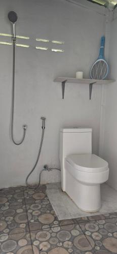 a white bathroom with a toilet and a shower at Ninja Camp - Dojo - Muay Thai Retreat in Baan Tai
