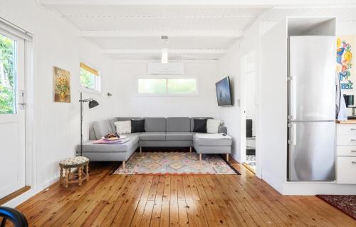 a living room with a couch and a refrigerator at Awesome Home In Ølsted With Wifi in Ølsted