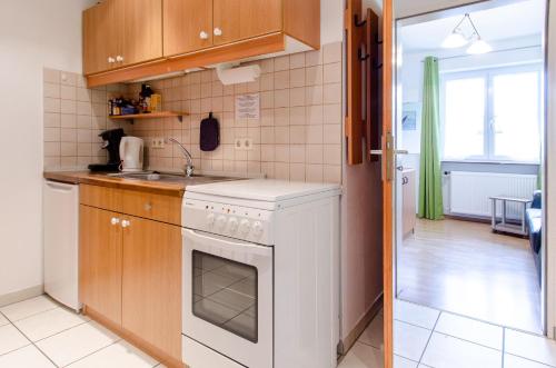 a kitchen with a white stove and a sink at Heizmannshof in Hofstetten