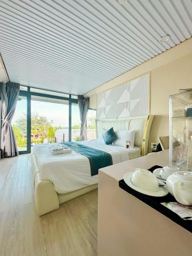 a bedroom with a bed and a table with plates on it at Olee SeaView Resort in Mui Ne