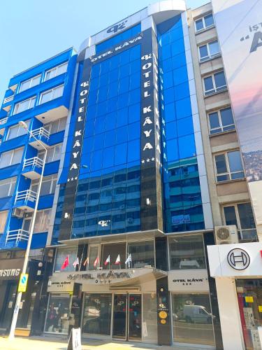 a building with blue windows on a city street at OTEL KÂYA in Izmir