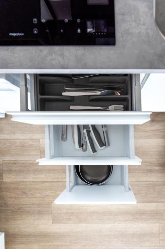a white table with utensils on it at Apartment mit vier Einzelboxspringbetten - Netflix in Goch