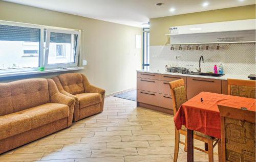 a living room with a couch and a table and a kitchen at Gorgeous Home In Boruja in Boruja