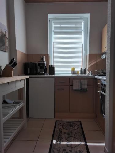 a kitchen with a sink and a window at Ferienwohnung am Bahnhof Meierstr 43 in Lübeck