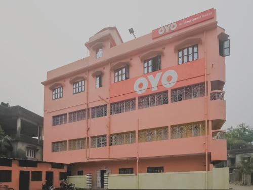 a pink building with an ovo sign on it at Hotel O Krishna Guest House Siliguri Railway Station in Panchanai