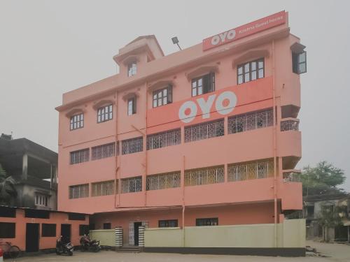 a pink building with an ovo sign on it at Hotel O Krishna Guest House Siliguri Railway Station in Panchanai