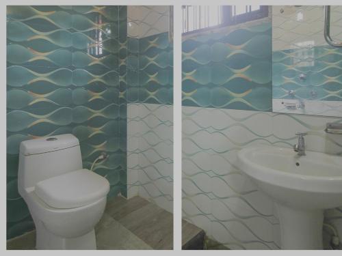 a bathroom with a toilet and a sink at Hotel O Krishna Guest House Siliguri Railway Station in Panchanai