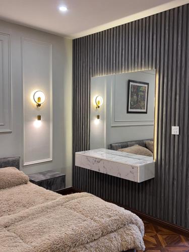 a bedroom with two beds and a large mirror at Blue sky Apartment in Nathia Gali