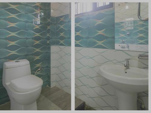 a bathroom with a toilet and a sink at Hotel O Krishna Guest House Siliguri Railway Station in Panchanai