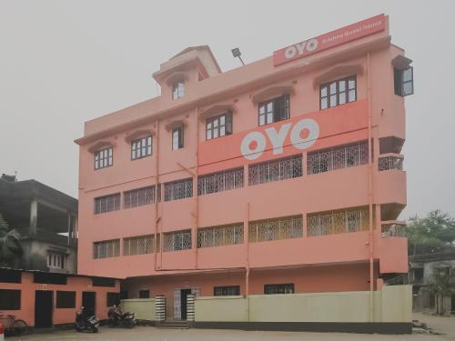 a pink building with an ovo sign on it at Hotel O Krishna Guest House Siliguri Railway Station in Panchanai