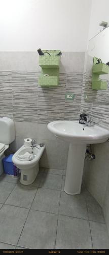 a bathroom with a sink and a toilet at EnjoyCasa Tra Sole Mare e L'Etna in Adrano
