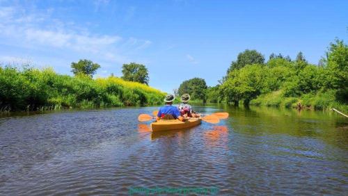 a group of people in a kayak on a river at Zacisze u Rysia in Brochów