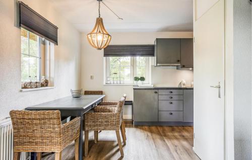 a kitchen with a dining room table and chairs at 3 Bedroom Cozy Home In Paasloo in Paasloo