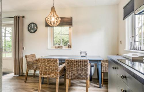 a dining room with a blue table and chairs at 3 Bedroom Cozy Home In Paasloo in Paasloo