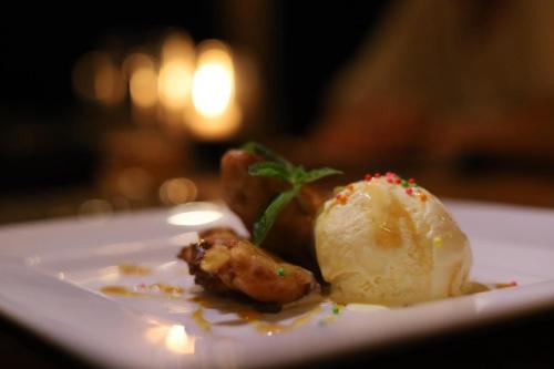 a plate of food with ice cream on a table at The Coconut Experience Eco Lodge Wilpattu 