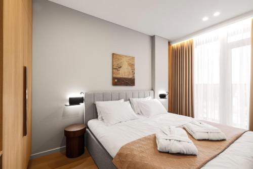 Postel nebo postele na pokoji v ubytování Aparthotel Nemunas