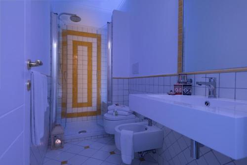 a bathroom with a sink and a toilet and a shower at Vista d'Amalfi in Amalfi