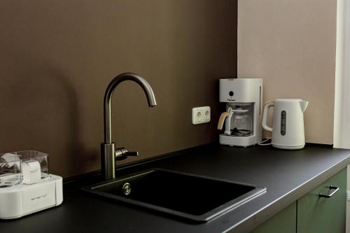 a kitchen counter with a sink and a coffee maker at Ferienhaus Arina in Bad Bertrich