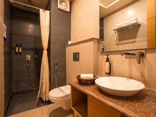 a bathroom with a sink and a toilet and a shower at Moustache Rishikesh Luxuria in Rishīkesh