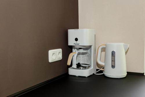 a coffee maker and a coffeemaker sitting on a counter at Ferienhaus Arina in Bad Bertrich