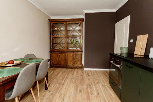 a kitchen with a table and chairs and a cabinet at Ferienhaus Arina in Bad Bertrich