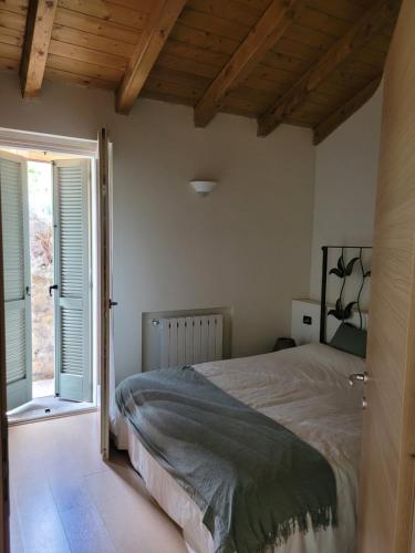 a bedroom with a bed and a large window at La Bella Vista in Fonteno
