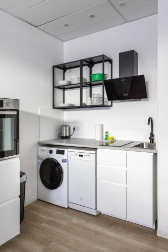 a white kitchen with a washing machine in it at Apartment - 3 Einzelbetten - Stellplatz - Netflix in Goch