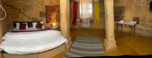 a bedroom with two beds in a room at Hotel Lotus Haveli in Jaisalmer