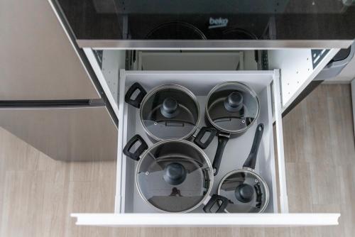 a bunch of pots and pans in a cabinet at Apartment - 3 Einzelbetten - Stellplatz - Netflix in Goch