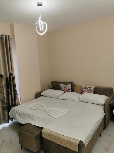 a bed in a room with a bed frame at SeaBreeze Apartments in Golem