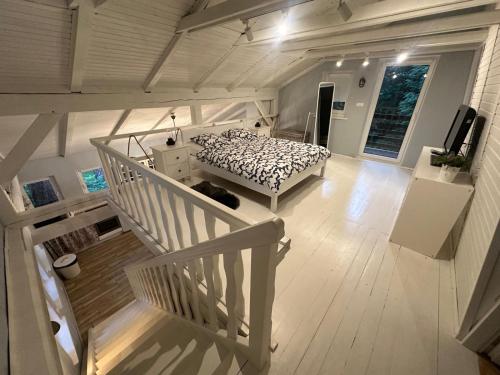 a bedroom with a bed and a staircase in a house at Lawenda in Turawa