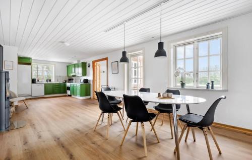 a kitchen and dining room with a table and chairs at 3 Bedroom Beautiful Home In Videbæk in Videbæk