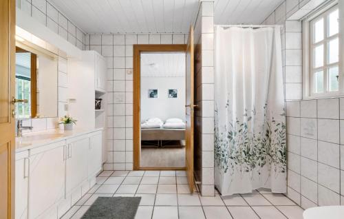 a bathroom with a shower with a shower curtain at 3 Bedroom Beautiful Home In Videbæk in Videbæk
