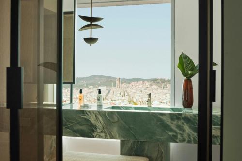 a bathroom with a counter with a large window at Hotel Arts Barcelona in Barcelona