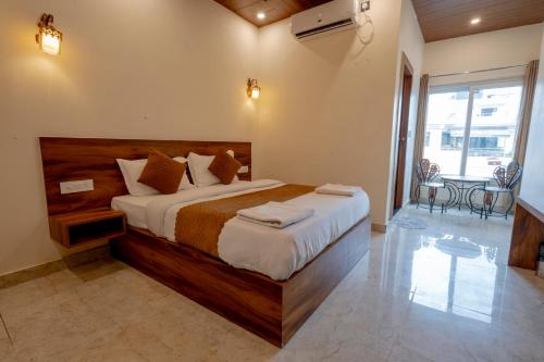 a bedroom with a large bed in a room at Hotel Relax Inn Ganga Rishikesh in Rishīkesh