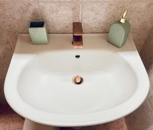 a white sink with two candles on top of it at Zoe City Home in Corfu