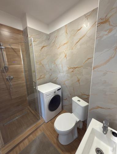 a bathroom with a toilet and a shower and a sink at Apartmány Hviezdoslavova in Piešťany