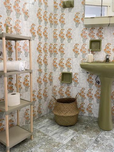 a bathroom with a sink and a toilet and a basket at Philoxenia Apartments in Samos