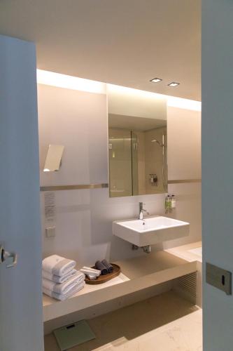 a bathroom with a sink and a mirror at Brasil Suites Boutique Hotel in Athens