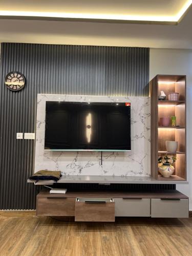 a living room with a large television on a wall at Blue sky Apartment in Nathia Gali