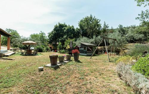 a garden with a swing and a playground at Apartment In Villa With Pool in Callas