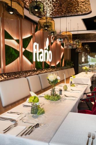 a long table in a restaurant with white tables and silverware at Wings Plaza in Kraków
