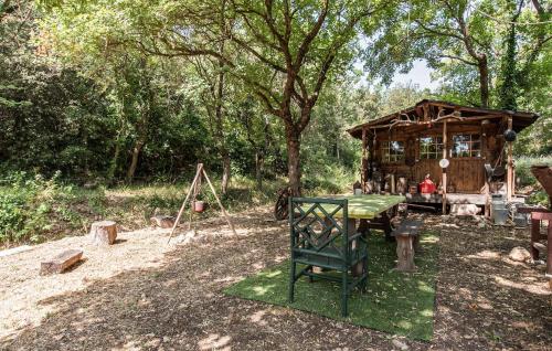 a picnic table in front of a wooden building at Apartment In Villa With Pool in Callas