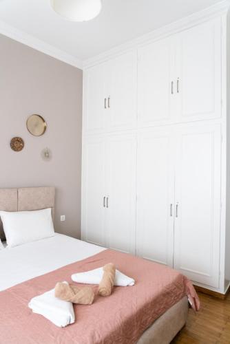 a bedroom with a large bed with white cabinets at Seaside Casa in Nafpaktos