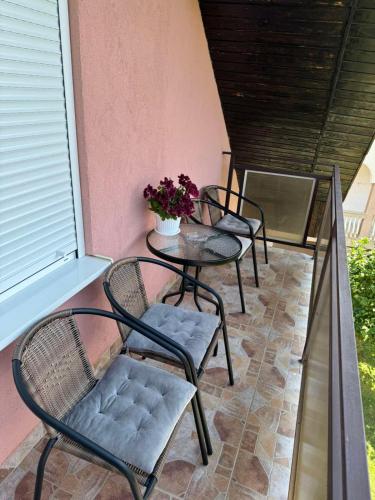a group of chairs and tables on a balcony at Apartment Mountain Paradise Plav in Plav