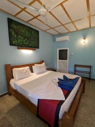 a bedroom with a large white bed in a room at Eco Hotel Black & White - Anuradhapura in Mihintale