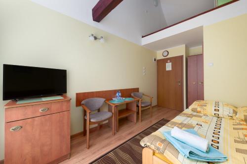 a hotel room with two beds and a flat screen tv at Malinka in Rewal