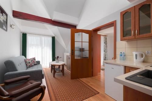 a living room with a couch and a kitchen at Malinka in Rewal