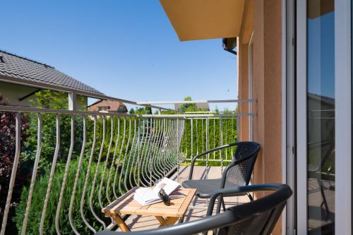 a balcony with two chairs and a table on a porch at Malinka in Rewal
