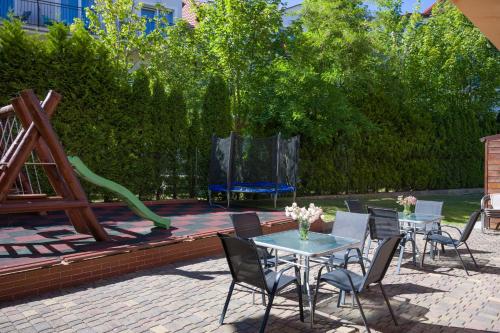 a patio with a table and chairs and a playground at Malinka in Rewal